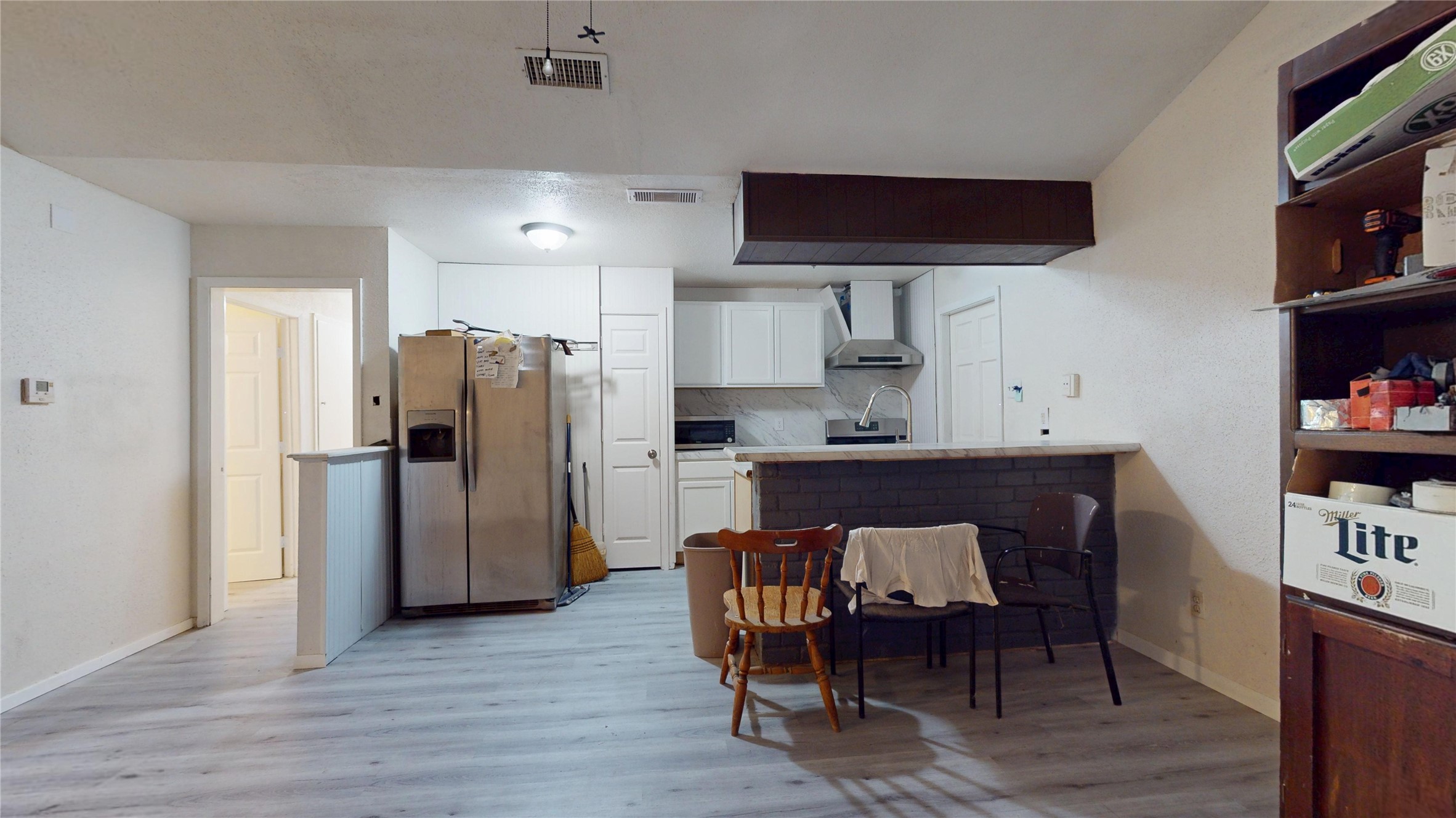 7115 Inkberry Drive Houston, TX 77092 - Photo 8 of 31 a kitchen with stainless steel appliances granite countertop a refrigerator a stove a sink and a dining table with wooden floor