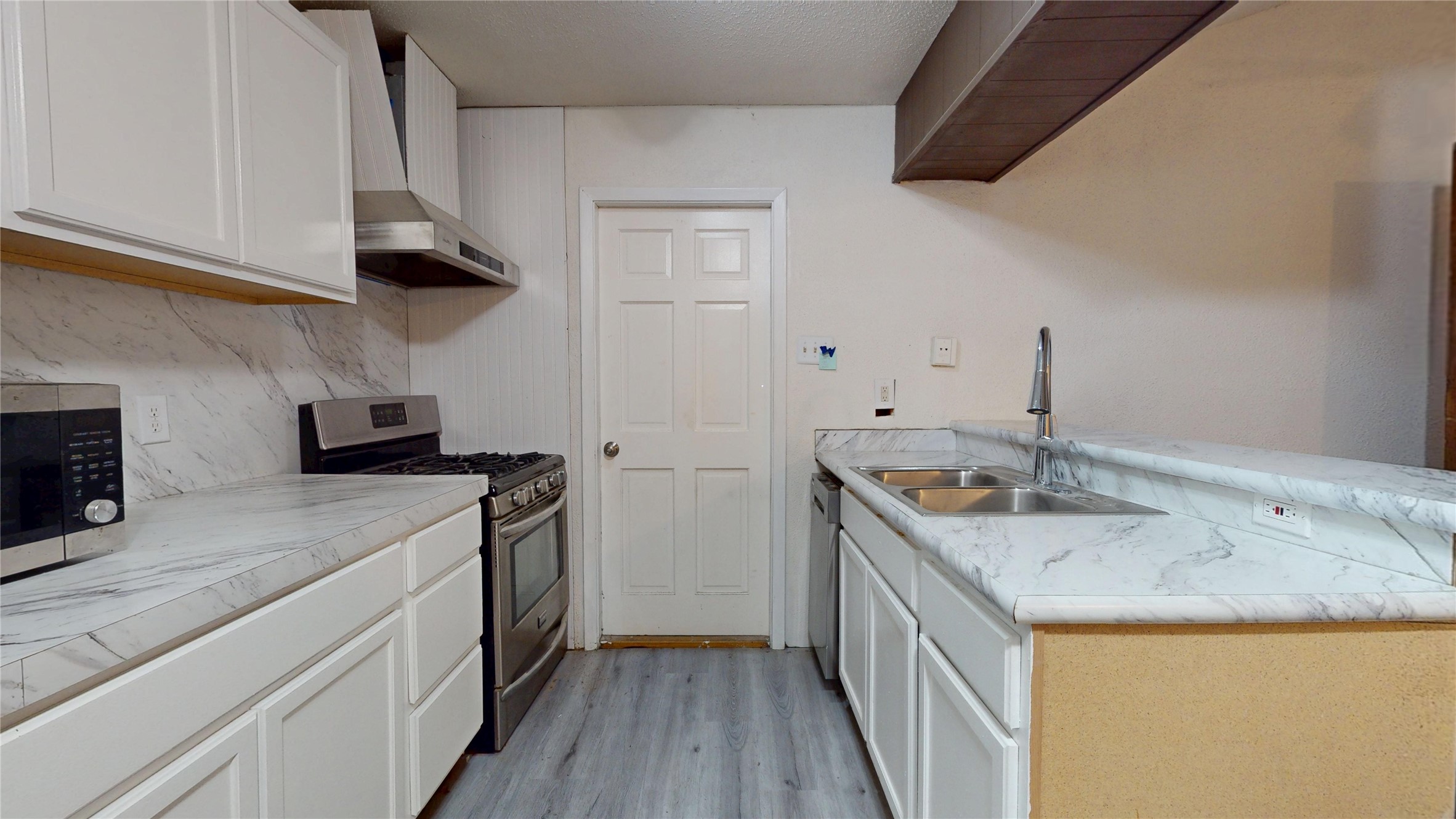 7115 Inkberry Drive Houston, TX 77092 - Photo 10 of 31 a kitchen with a sink and a stove top oven