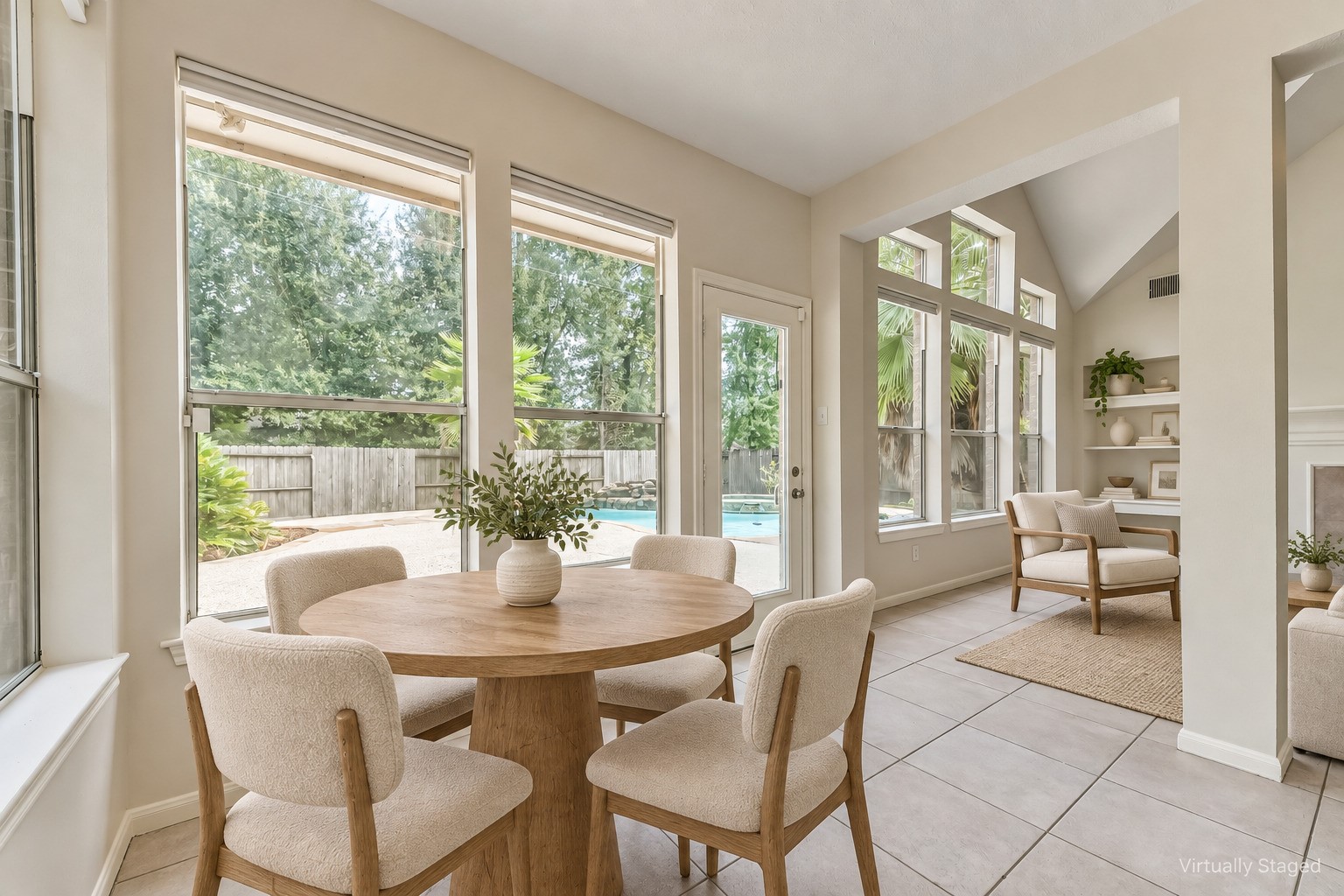 6338 Maple Spring Place Humble, TX 77346 - Photo 17 of 50 Virtually staged — Morning coffee comes with a pool view in this bright breakfast nook. Easy patio access and a connection to the living room make it an inviting spot for casual meals and weekend gatherings.