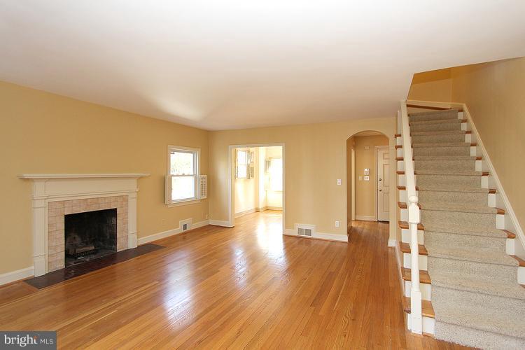 1214 Portner Road Alexandria, VA 22314 - Photo 11 of 21 a view of empty room with wooden floor and fireplace