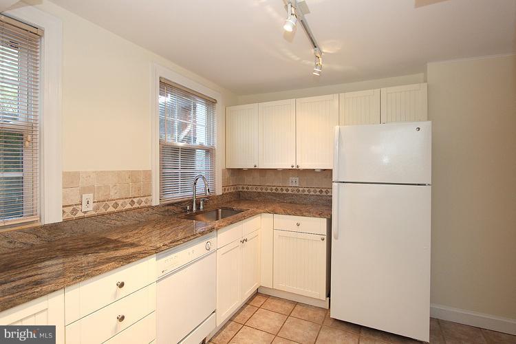 1214 Portner Road Alexandria, VA 22314 - Photo 13 of 21 a kitchen with a refrigerator sink and cabinets