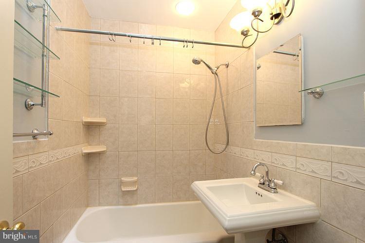 1214 Portner Road Alexandria, VA 22314 - Photo 14 of 21 a bathroom with a sink a toilet and shower