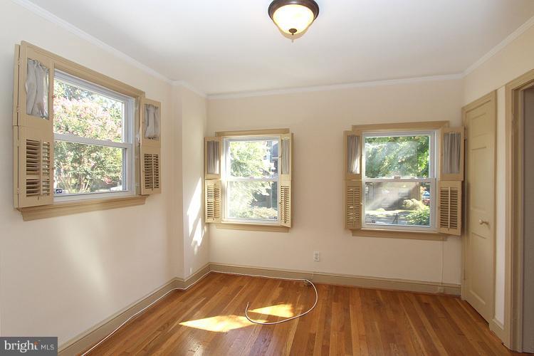 1214 Portner Road Alexandria, VA 22314 - Photo 15 of 21 a view of an empty room with wooden floor and a window