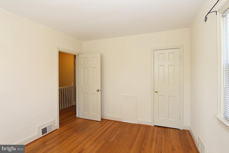 1214 Portner Road Alexandria, VA 22314 - Photo 3 of 21 a view of an empty room with wooden floor and closet