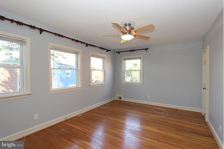 1214 Portner Road Alexandria, VA 22314 - Photo 4 of 21 a view of an empty room with wooden floor and a window