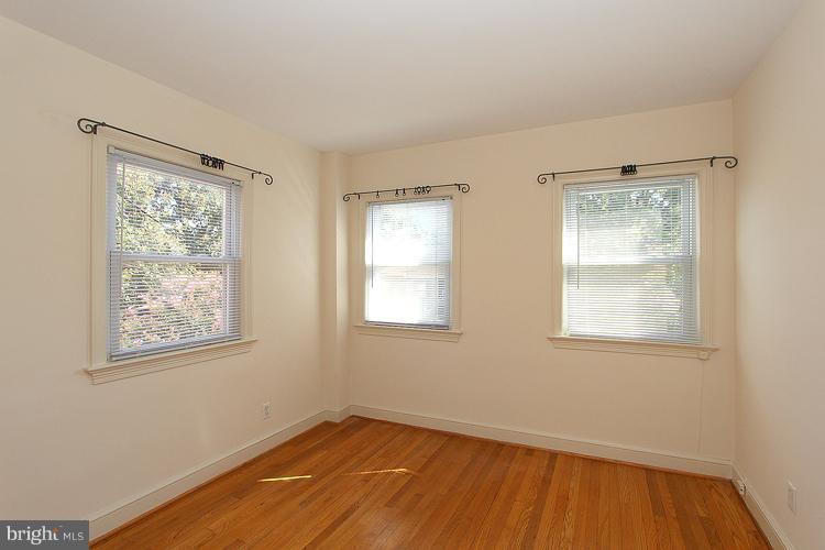 1214 Portner Road Alexandria, VA 22314 - Photo 8 of 21 a view of an empty room with wooden floor and a window