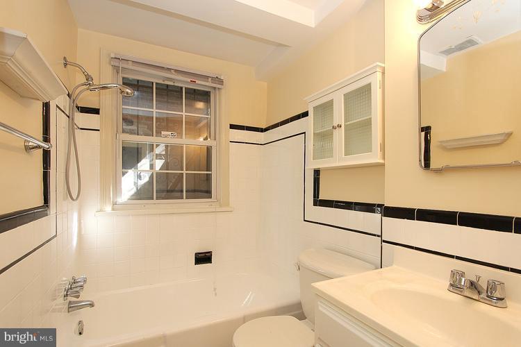 1214 Portner Road Alexandria, VA 22314 - Photo 9 of 21 a bathroom with a sink a toilet and shower