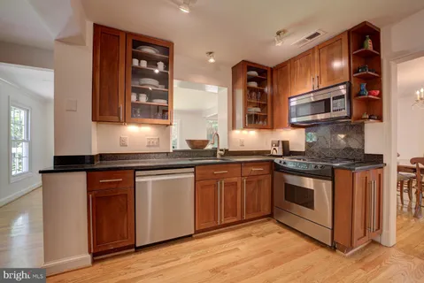 a kitchen with stainless steel appliances granite countertop a stove and a sink