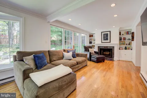 a living room with furniture large window and a fireplace