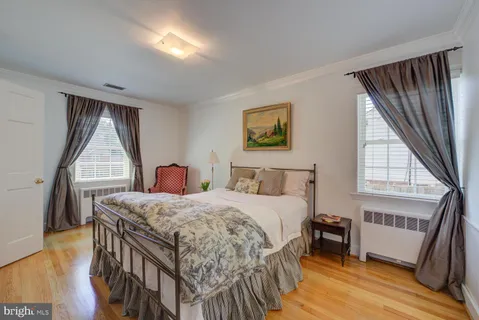 a bedroom with a bed next to a window