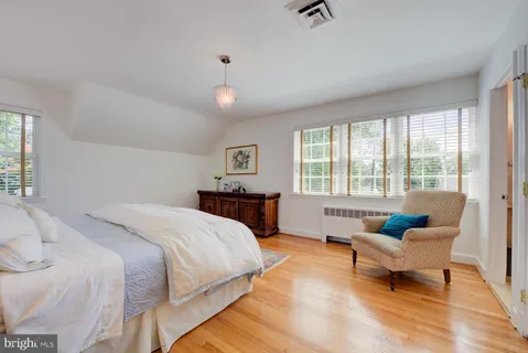 a spacious bedroom with a bed and a couch