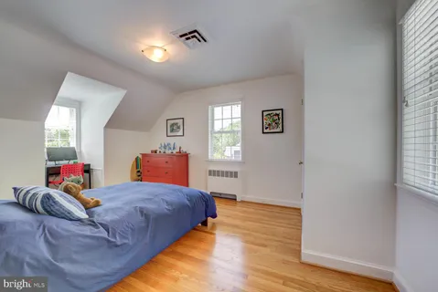 a bed room with two beds and a window