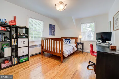 a bedroom with furniture window and flat screen tv