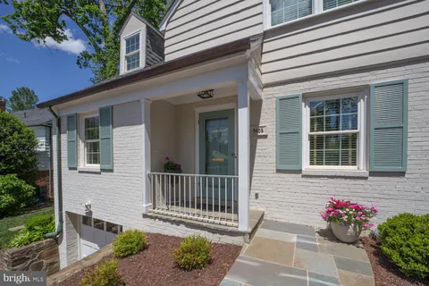 a view of a house with a small yard and a flower garden