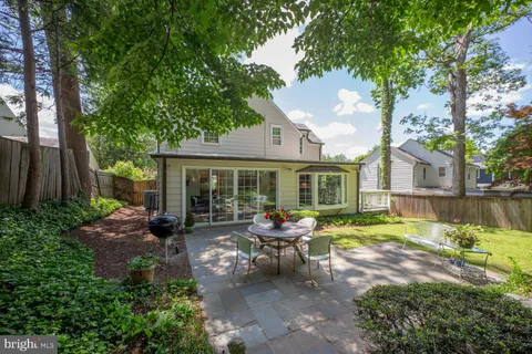 a view of a house with backyard sitting area and garden