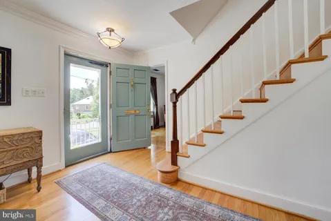 a view of entryway and hall with wooden floor