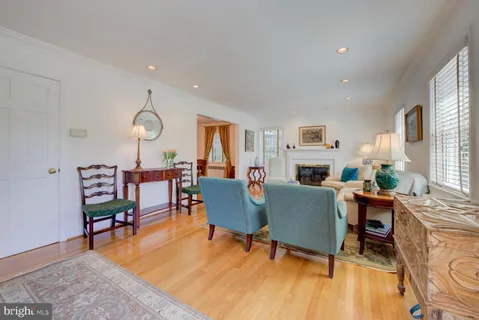 a living room with fireplace furniture and a wooden floor