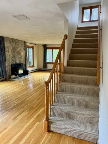 a view of entryway and hall with wooden floor