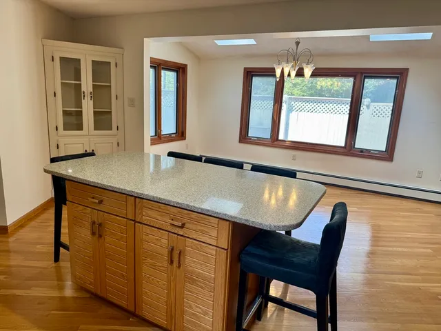 a view of a dining room with furniture and chandelier