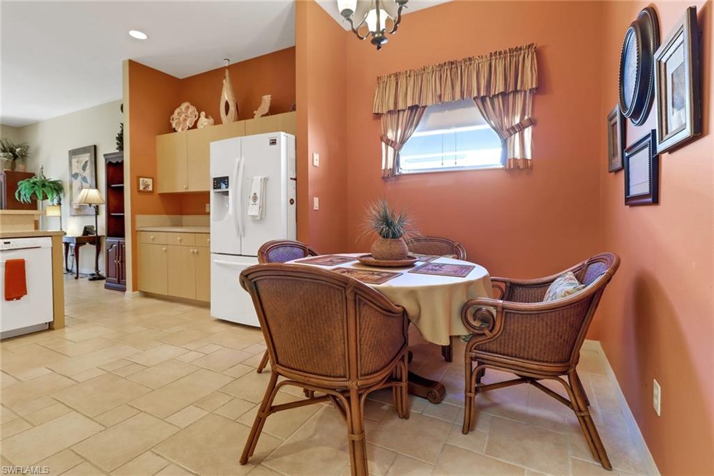 9312 Sun River Way Estero, FL 33928 - Photo 13 of 45 a dining room with furniture and window