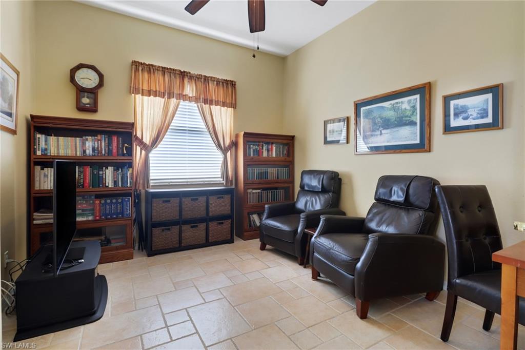 9312 Sun River Way Estero, FL 33928 - Photo 17 of 45 a living room with furniture a window and bookshelf