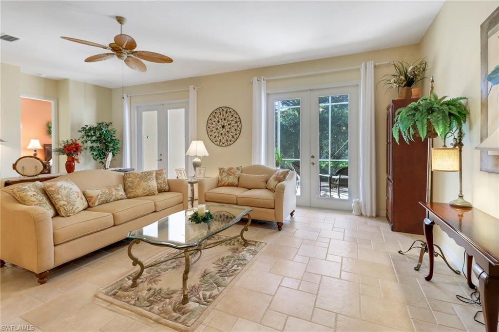9312 Sun River Way Estero, FL 33928 - Photo 9 of 45 a living room with furniture a chandelier and a window
