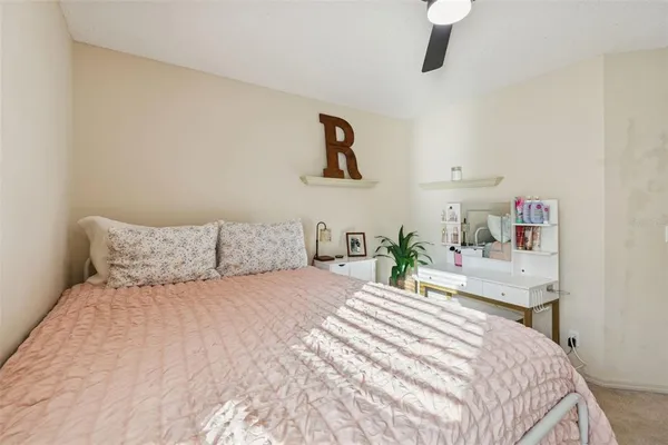 an aerial view of residential houses with outdoor space and trees