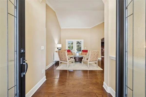 a living room with furniture and a large mirror