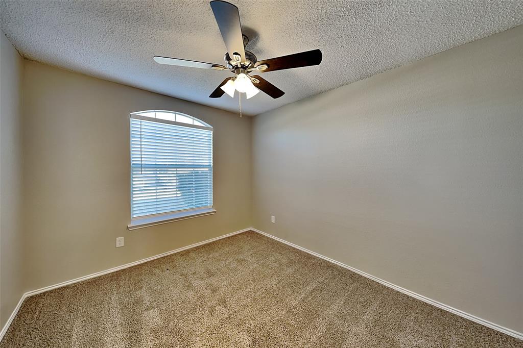 3304 Athens Drive Corinth, TX 76210 - Photo 13 of 22 an empty room with windows and fan