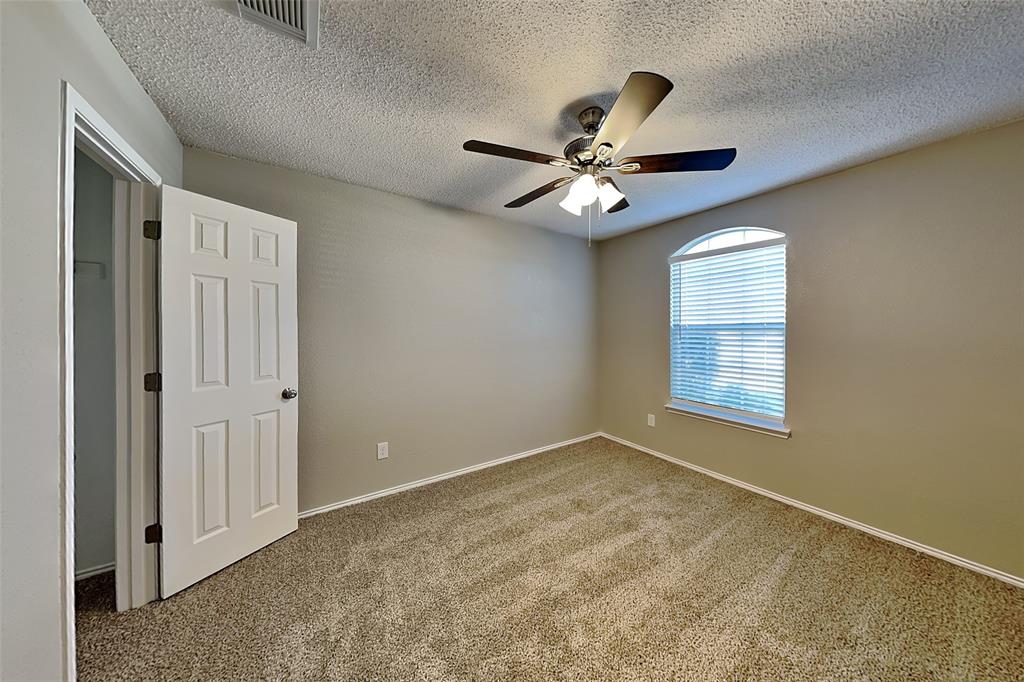 3304 Athens Drive Corinth, TX 76210 - Photo 15 of 22 an empty room with windows and fan