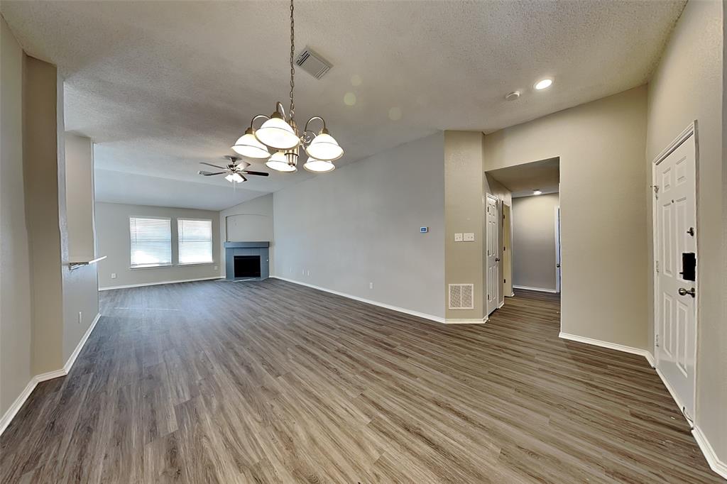 3304 Athens Drive Corinth, TX 76210 - Photo 2 of 22 a view of a livingroom with a chandelier front door and wooden floor