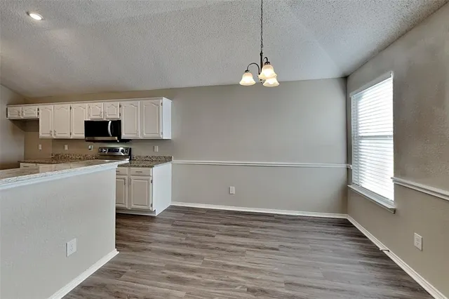 a view of microwave and cabinets