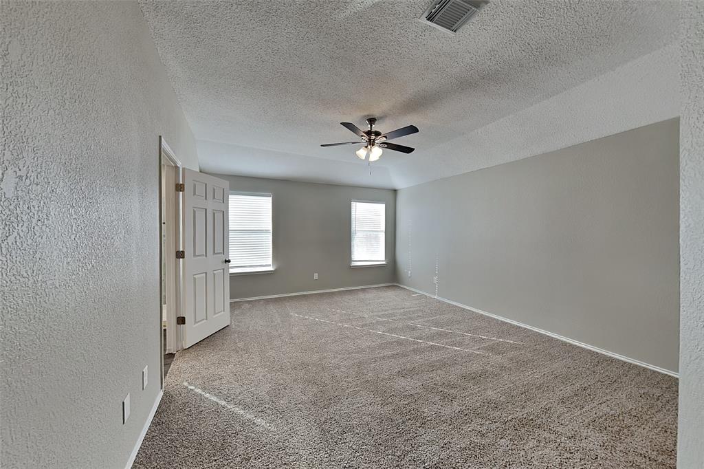 3304 Athens Drive Corinth, TX 76210 - Photo 8 of 22 a view of an empty room with a ceiling fan