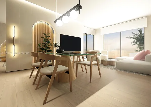 a living room with a couch and a potted plant