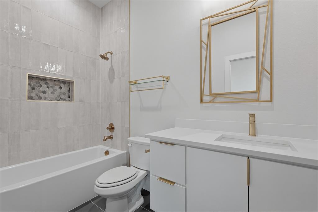 3914 Harlingen Street Dallas, TX 75212 - Photo 12 of 28 a bathroom with a sink toilet vanity and shower