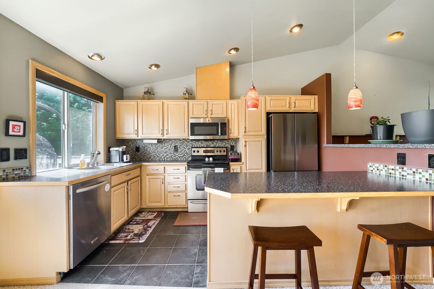 1008 R Street Northwest Auburn, WA 98001 - Photo 10 of 32 a large kitchen with kitchen island granite countertop a large counter top stainless steel appliances and cabinets