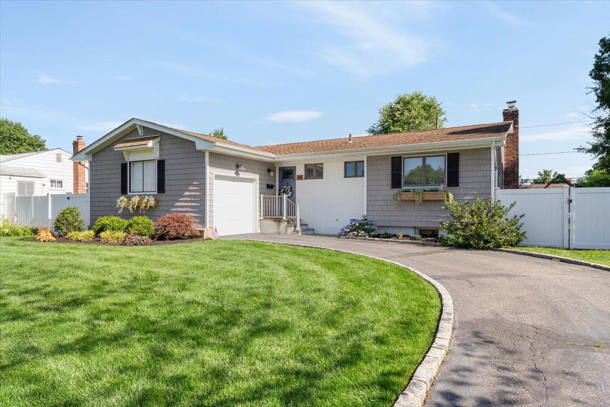 a front view of house with yard and green space