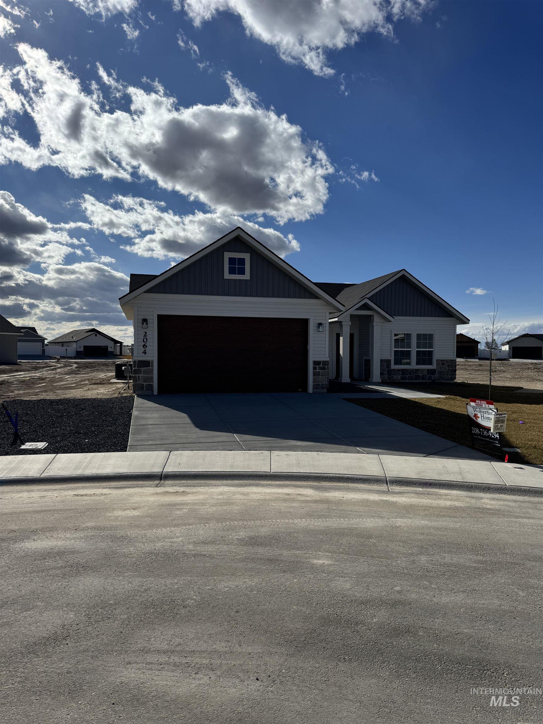 2064 Harrison Street South Twin Falls, ID 83301 - Photo 25 of 29 View of front of home featuring concrete driveway, board and batten siding, a garage, and stone siding