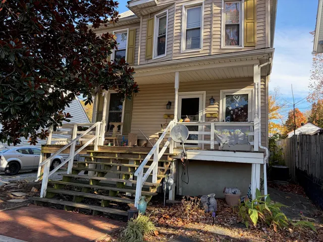 a view of a house with couches chairs and a fire pit