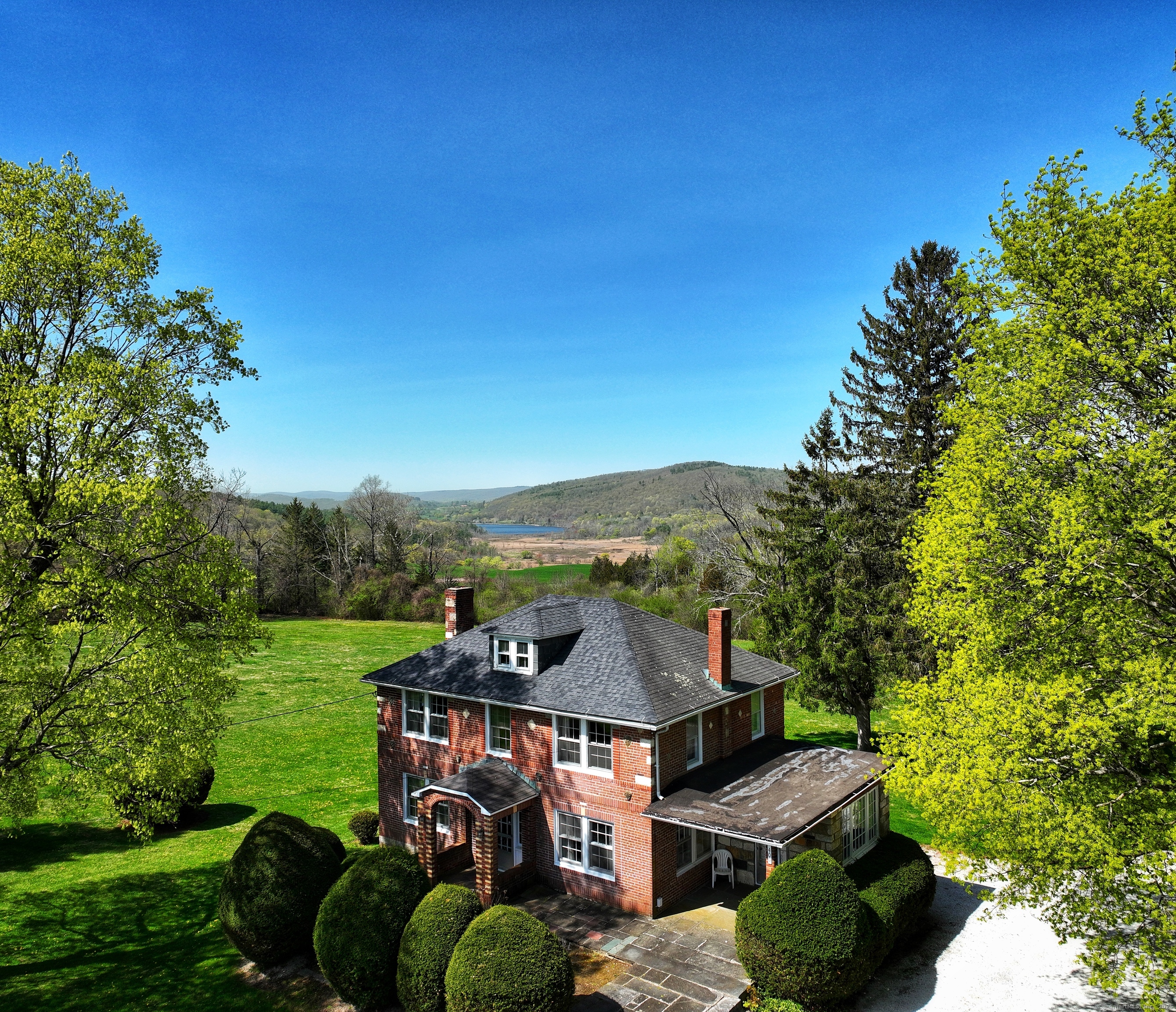 400 Gay Street Sharon, CT 06069 - Photo 2 of 8 a view of a big yard with potted plants and large tree