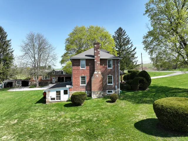 a front view of a house with yard and green space