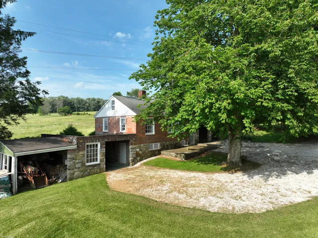 a front view of a house with a garden and yard