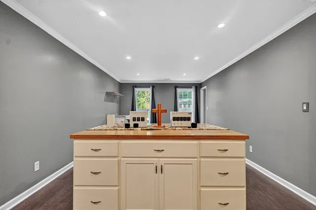 a kitchen with sink a mirror and cabinets