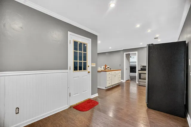 an empty room with a window and ceiling fan