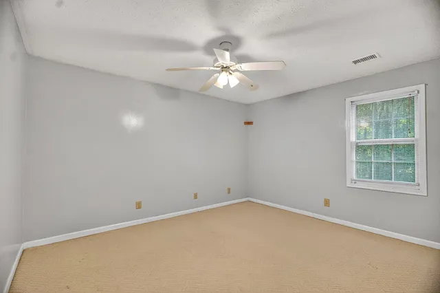 a view of wooden floor and windows in a room