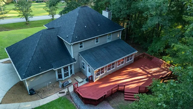 a view of a deck with wooden floor and fence
