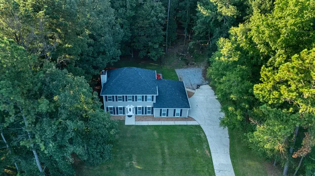 an aerial view of a house with a yard