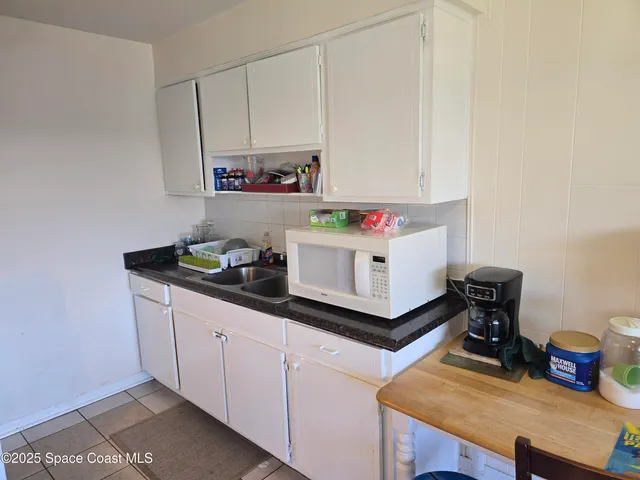 a kitchen with a sink cabinets and window