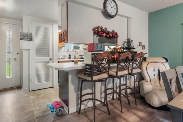 a view of living room filled with furniture and a chandelier