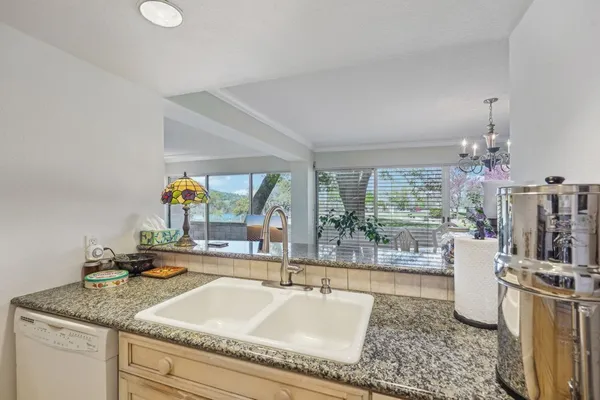 a living room with granite countertop furniture and a floor to ceiling window